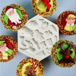 Person with Christmas cake mold Australia Pink color, front view, showing Santa/deer shape.