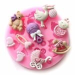 Person with baby shower molds Australia Pink color, front view, showing silicone design.