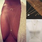 Person with waist body chain Australia Gold color, front view, showing moon and crystals.