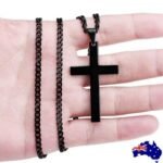 Person with titanium cross necklace Australia Silver color, front view, showing cross pendant.