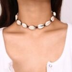 Person with shell choker necklace Australia Natural color, front view, showing shell charms.