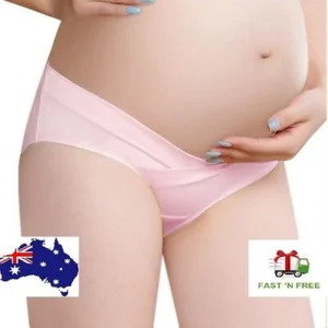 Pregnant woman in maternity low waist panties Pink color, front view, showing stretchy fit.