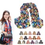 Woman in silk chiffon scarf wrap Red horse pattern, front view, showing long design.