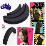 Woman using fluffy bangs clip Black color, front view, showing stereoscopic design.