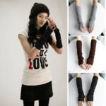 Woman in stretchy fingerless arm warmers Grey color, front view, showing knitted design.