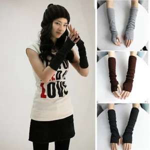 Woman in stretchy fingerless arm warmers Grey color, front view, showing knitted design.