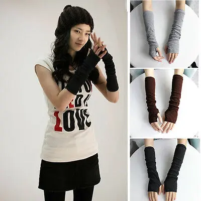 1-455.jpg Woman in stretchy fingerless arm warmers Grey color, front view, showing knitted design.