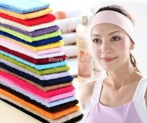 Person in cotton sports headband Australia Black color, front view, showing elastic design.