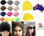 Person in hip hop beanie hat Australia Black color, front view, showing baggy design.