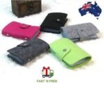 Person with unisex felt card wallet Australia Green color, front view, showing button closure.