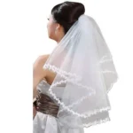 Bride with tulle wedding veil Australia White color, front view, showing lace edge.