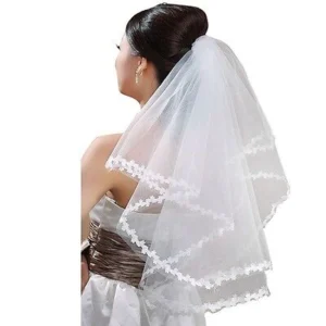 Bride with tulle wedding veil Australia White color, front view, showing lace edge.