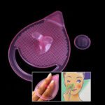 Person with silicone facial cleansing brush Australia Pink color, front view, showing silicone pad.