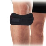 Person with patella tendon brace Australia Black color, front view, showing strap design.