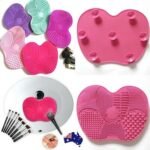 Person with makeup brush cleaner pad Australia Shown color, front view, showing silicone texture.