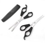 Person with hairdressing scissors set Australia Black color, front view, showing scissors and comb.