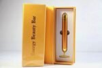 Person with 24K golden beauty bar Australia Gold color, front view, showing T-shaped head.