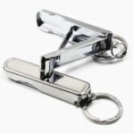 Person with folding nail clipper Australia Silver color, front view, showing folded design.