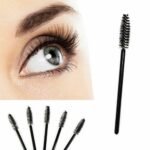 Person with disposable mascara wands Australia Black color, front view, showing synthetic bristles.