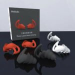 Person with silicone earplugs for sleep Australia Shown color, front view, showing tapered design.