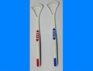 Person with tongue scraper Australia Red/Blue color, front view, showing scraper edge.