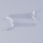 Person with dental cheek retractor Australia Clear color, front view, showing T-shape design.