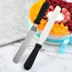 Person with cake spatula Australia Silver/Plastic color, front view, showing stainless steel blade.