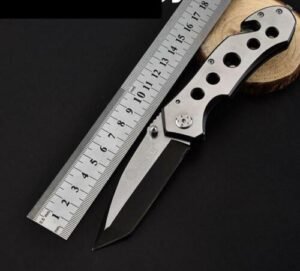 Person with camping knife Australia Steel color, front view, showing folded blade.