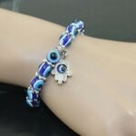 Person with evil eye bracelet Australia Blue color, front view, showing bead design.