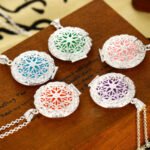 Person with aromatherapy necklace Australia Multi-color, front view, showing plant pattern.