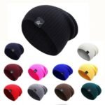 Person in slouchy winter beanie Black color, front view, showing knitted design.