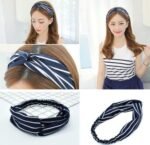 Woman using elastic yoga headband women Black color, front view, showing cross design.