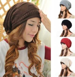 Person in autumn cotton beanie unisex Grey color, front view, showing knitted design.
