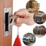 Person with portable travel door lock Australia Black color, front view, showing lock design.