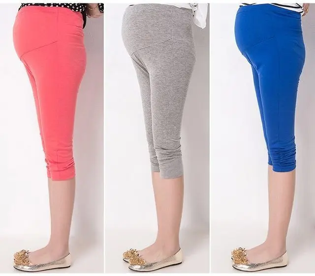 57-1474-1.jpg Woman in maternity capri leggings Black color, front view, showing adjustable waist.