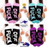 Person in funny novelty socks with letter print, front view, showing vibrant design.