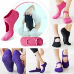 Woman in non slip yoga socks Black color, front view, showing grip design.