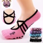 Woman in anti slip yoga socks, front view, showing grip dot design.