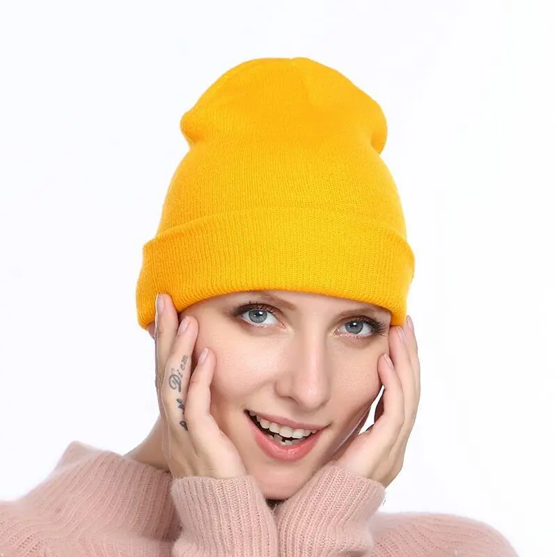57-1796-1.jpg Person in acrylic winter beanie hat Grey color, front view, showing knitted design.