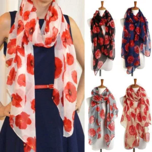 Woman in poppy print scarf Black color, front view, showing floral design.