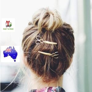 Woman using scissors pattern hair clip Black color, front view, showing geometric design.