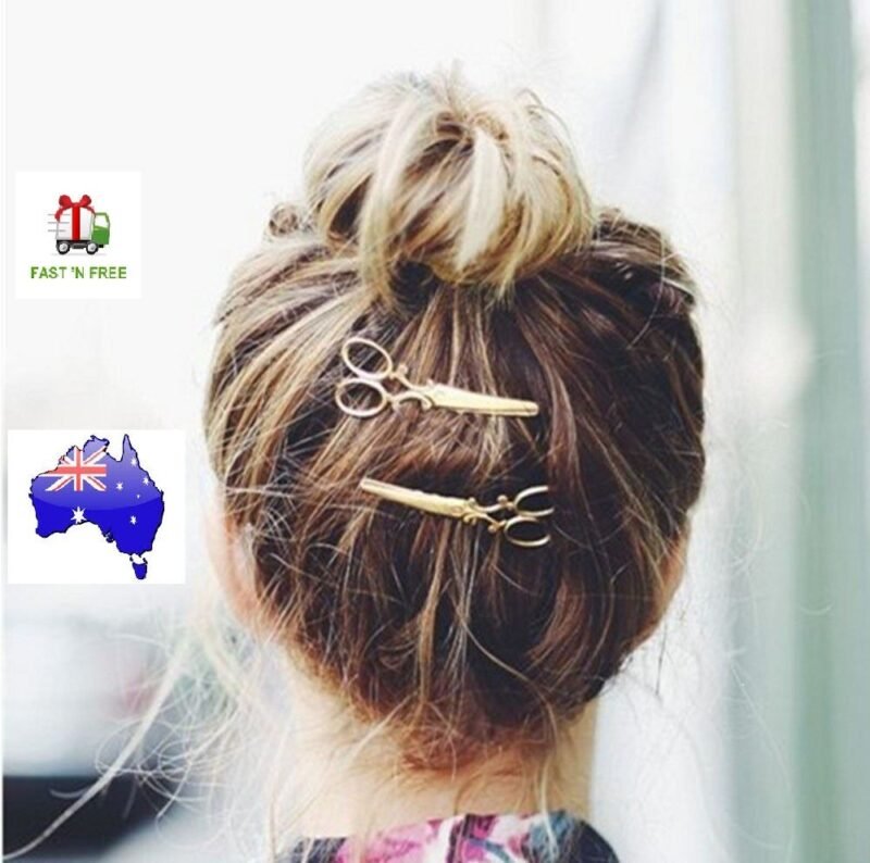 Woman using scissors pattern hair clip Black color, front view, showing geometric design.