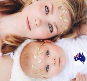 Woman and baby in mummy baby leaf headband Gold color, front view, showing leaf design.