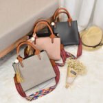 Woman with tassel PU leather handbag Black color, front view, showing flap design.