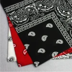 Person in paisley cotton bandana Australia Black color, front view, showing paisley design.