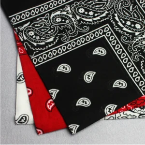 Person in paisley cotton bandana Australia Black color, front view, showing paisley design.