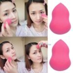 Person with makeup sponge Australia Shown color, front view, showing calabash shape.