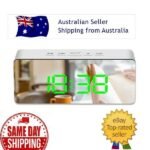Person with LED mirror clock Australia Black/White color, front view, showing mirror display.