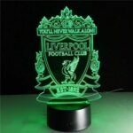 Person with Liverpool FC night light Australia Clear acrylic color, front view, showing 3D logo.