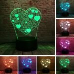 Person with heart night light Australia Clear acrylic color, front view, showing 3D heart.